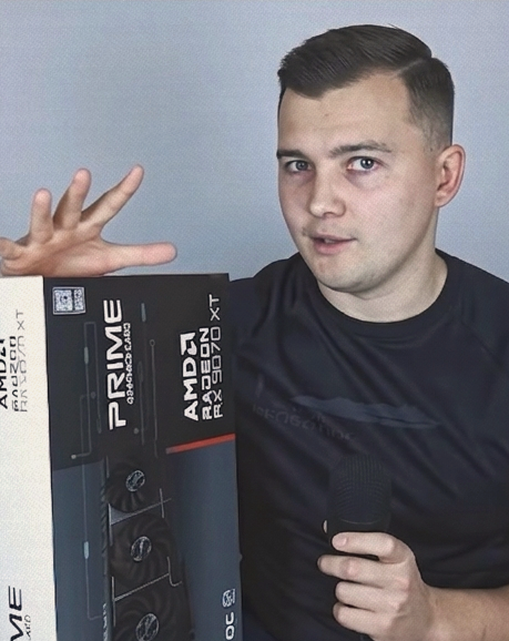 Andriy, technical content creator and hardware enthusiast, holding an AMD Radeon RX 9070 XT graphics card box.
