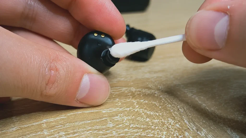 Applying cleaning solution to a wireless earbud