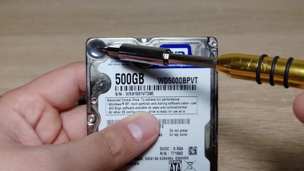 Removing a hidden screw from a laptop hard drive
