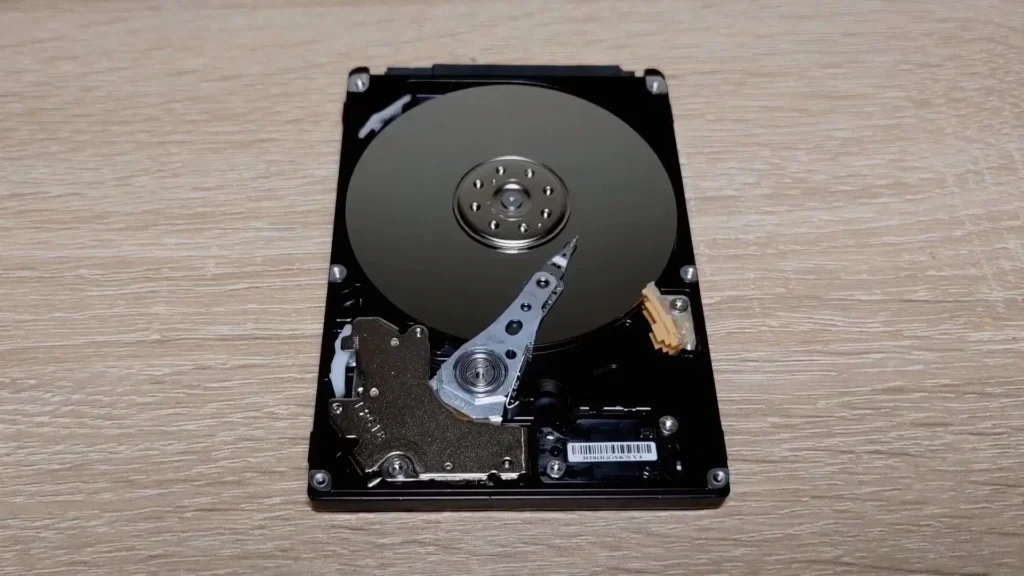 Opened laptop hard drive with exposed platter