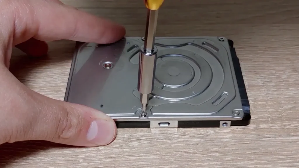 Removing screws from a laptop hard drive