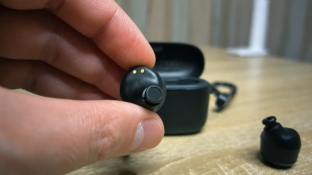 Close-up of a wireless earbud held in hand