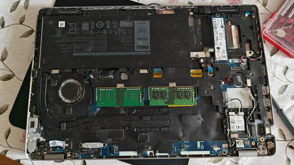 Dust buildup inside a laptop cooling system causing higher CPU temperatures