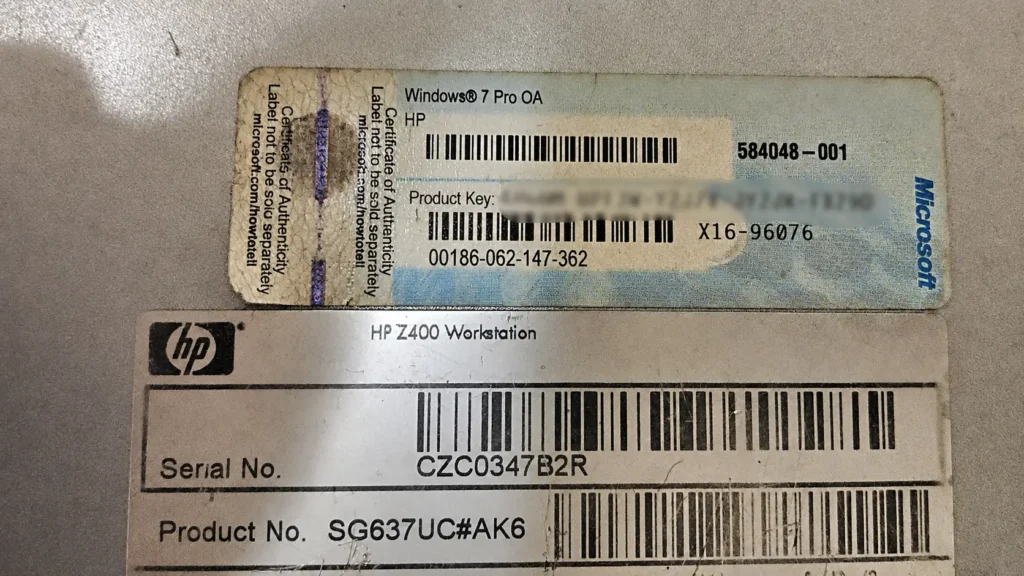 Windows 7 Certificate of Authenticity product key sticker on an HP workstation